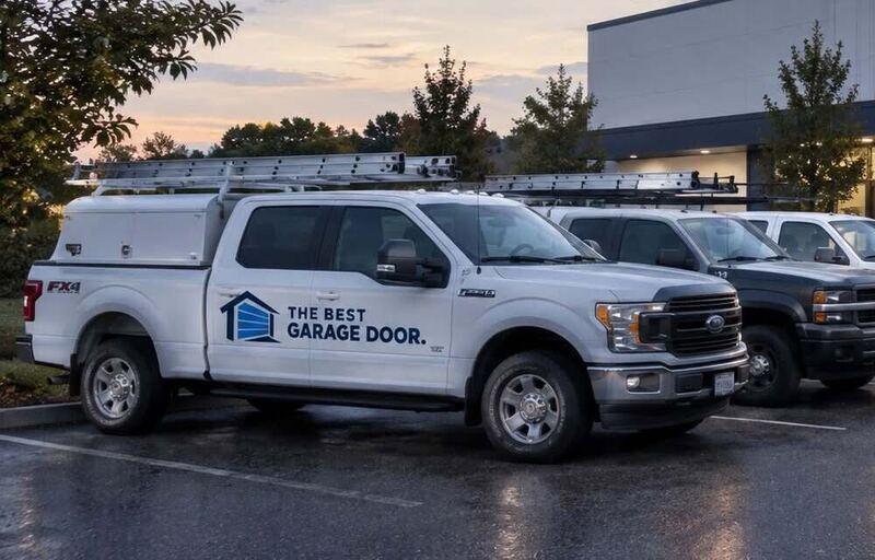 White pickup truck with The Best Garage Door logo and ladder rack